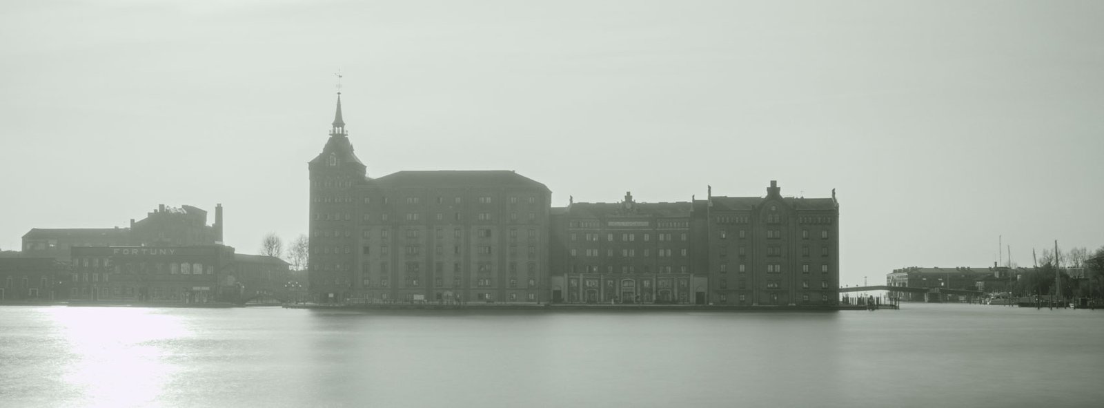 Black and white photograph of St Mark’s Square in Venice with strong leading lines and figures fading into mist