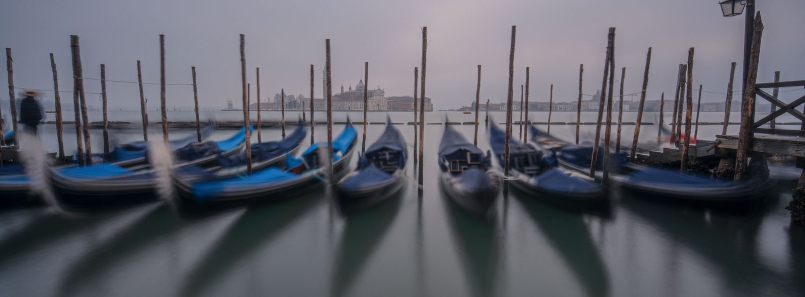 Black and white photograph of St Mark’s Square in Venice with strong leading lines and figures fading into mist